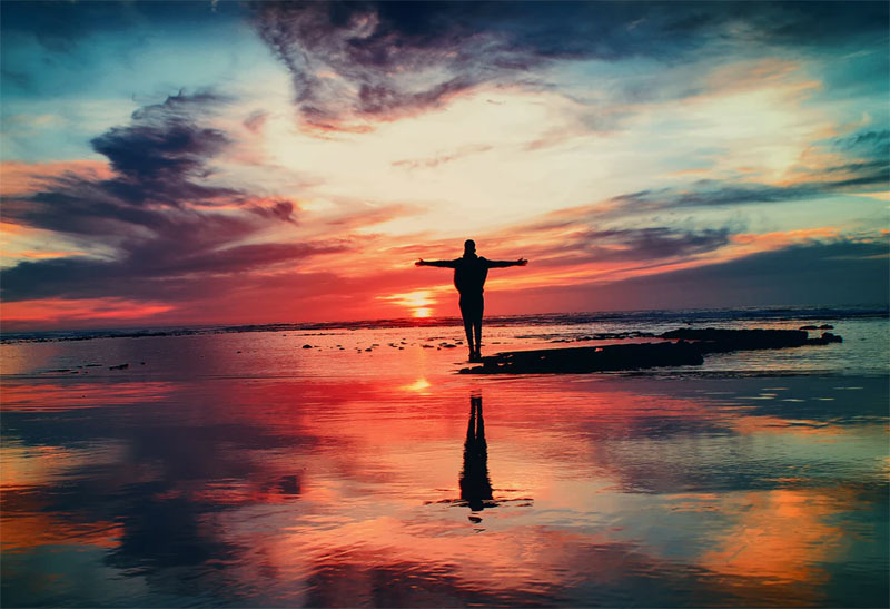 standing alone on beach sunset